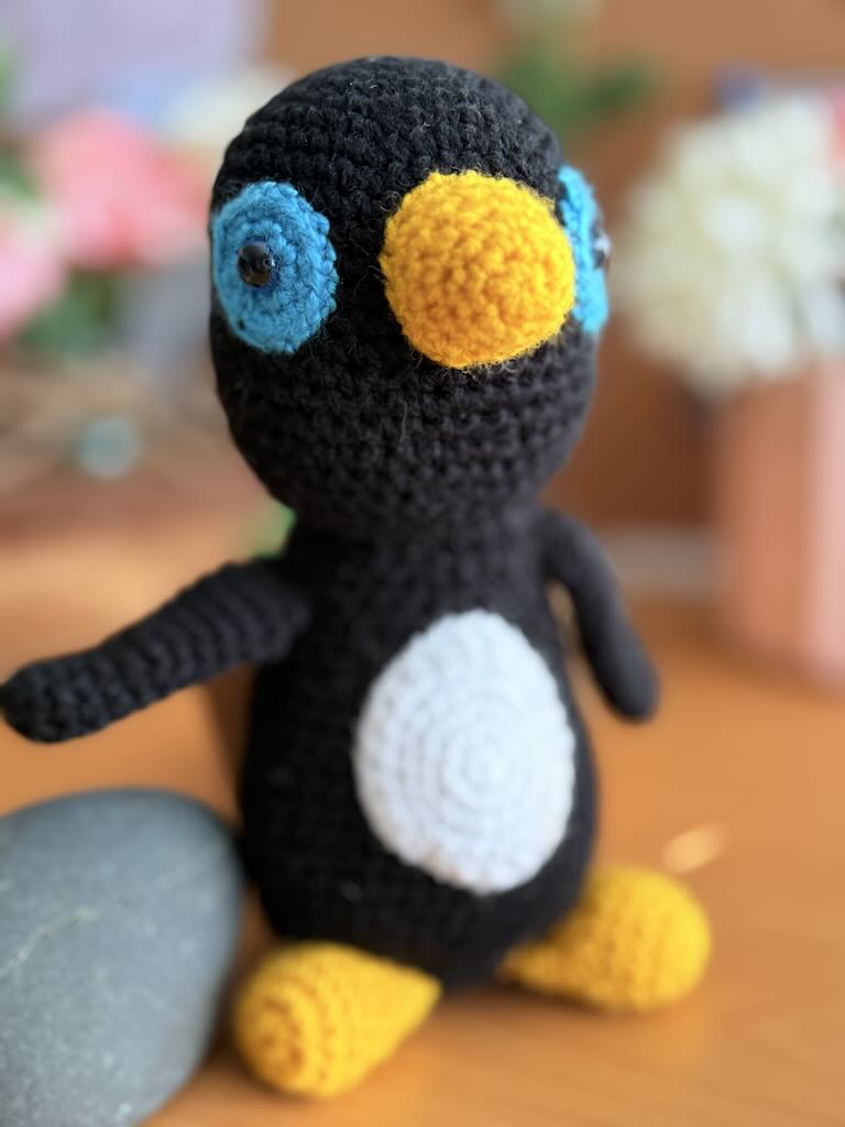 cute crochet penguin with a tiny beak and cozy round body