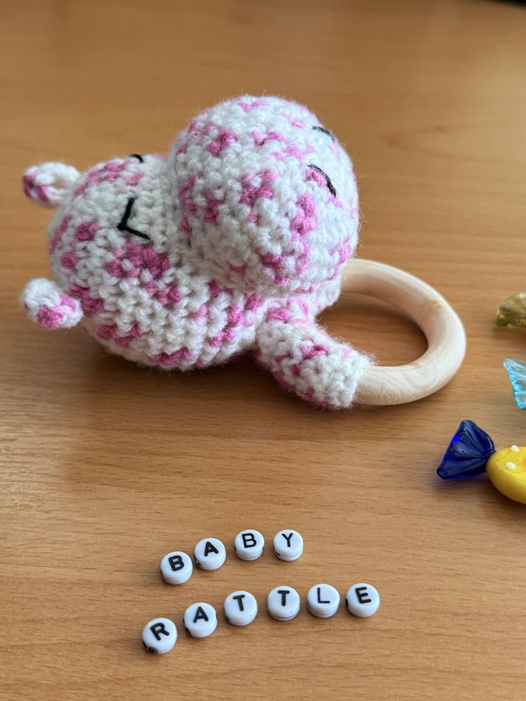 handmade crochet white hippo baby rattle with sweet smile and cozy feel