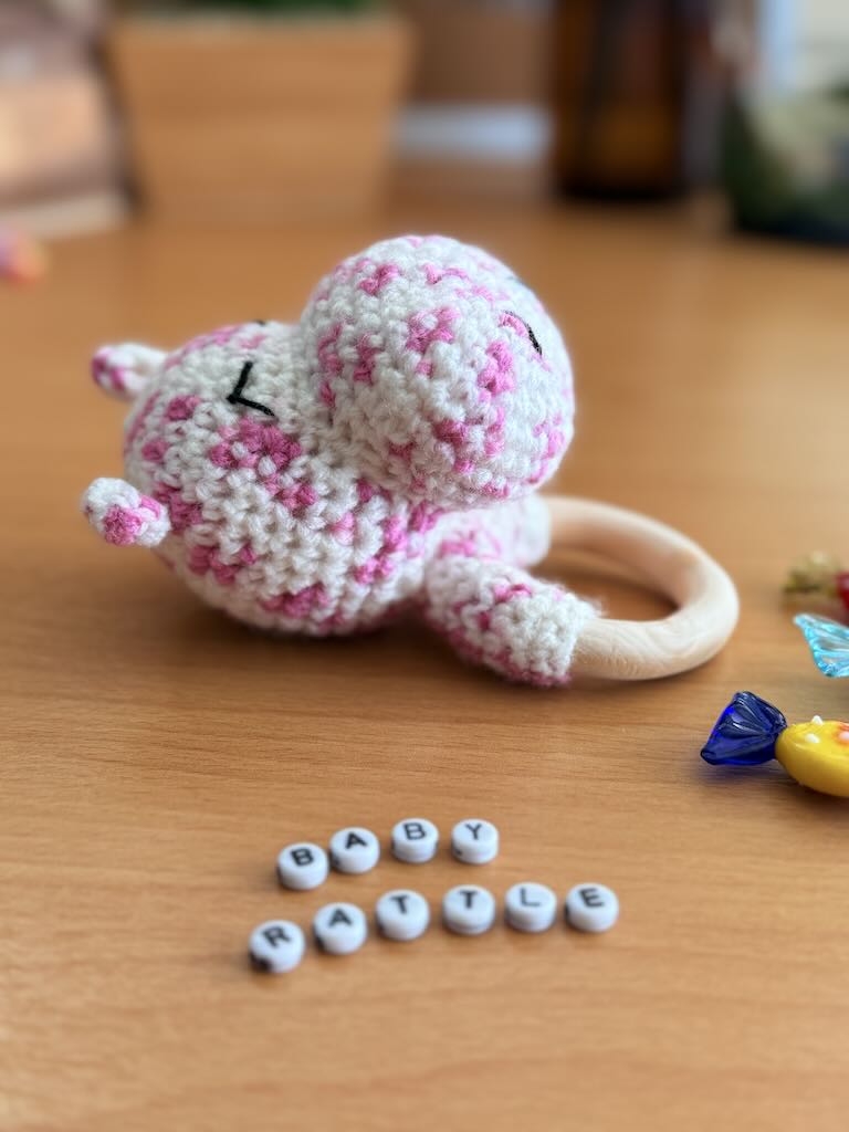 handmade crochet white hippo baby rattle with sweet smile and cozy feel