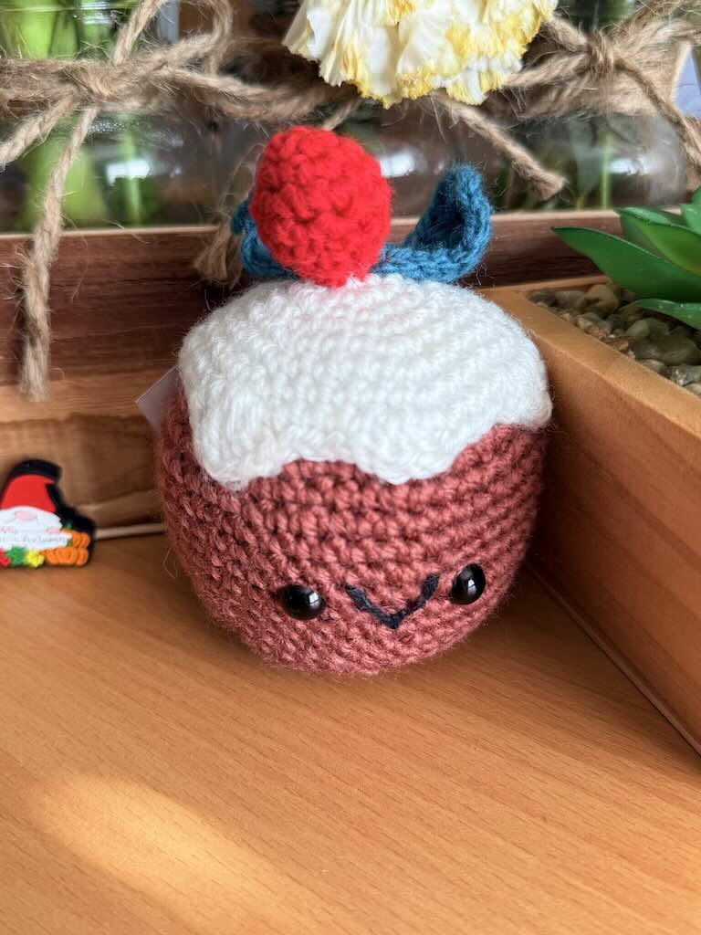 crochet christmas cake toy with festive decorations and colorful yarn