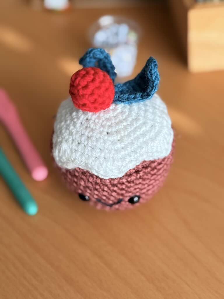 crochet christmas cake toy with festive decorations and colorful yarn