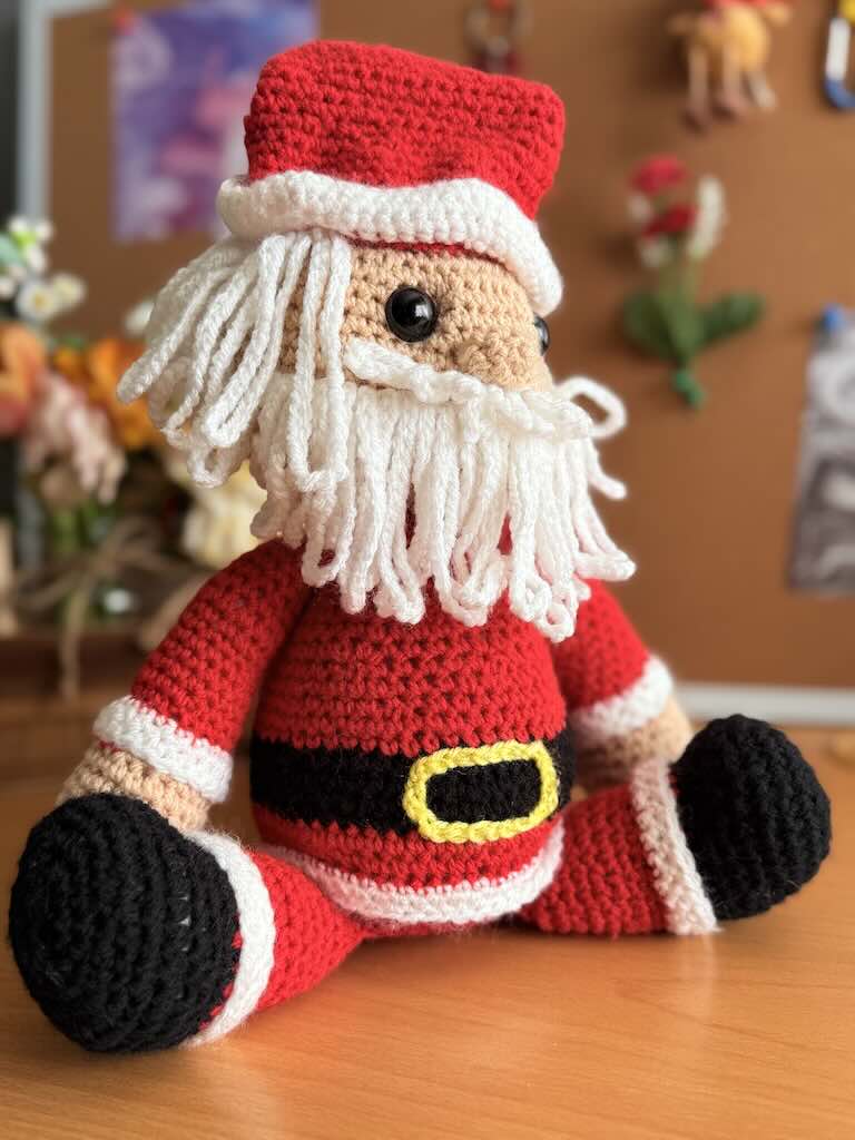 handmade crochet Santa Claus with red suit, hat, and white beard