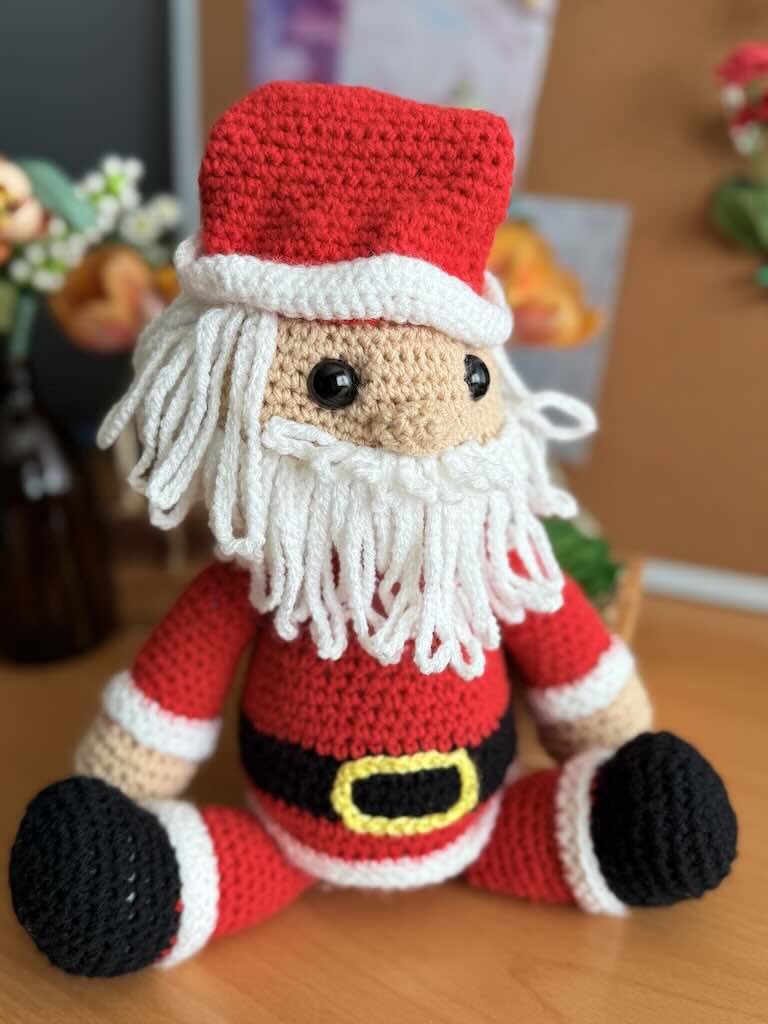 handmade crochet Santa Claus with red suit, hat, and white beard