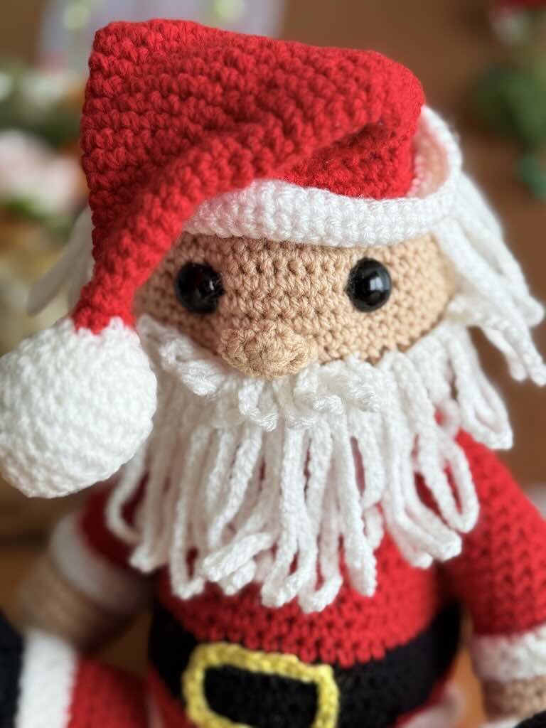 handmade crochet Santa Claus with red suit, hat, and white beard