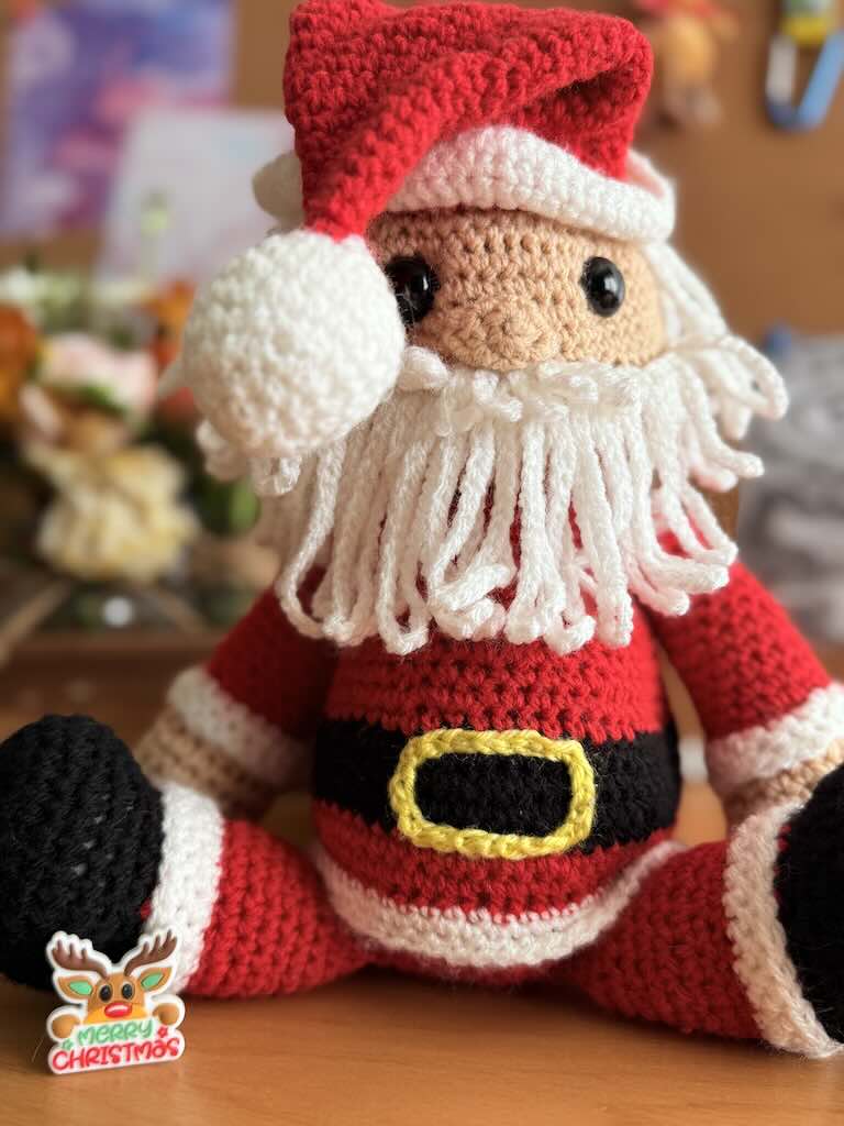 handmade crochet Santa Claus with red suit, hat, and white beard