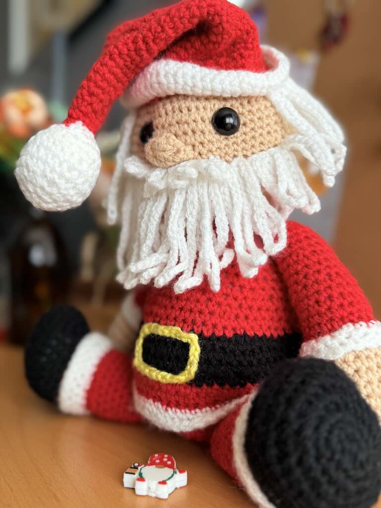handmade crochet Santa Claus with red suit, hat, and white beard