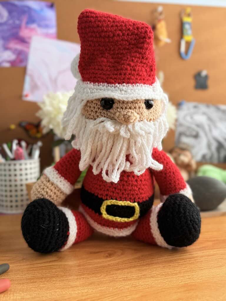 handmade crochet Santa Claus with red suit, hat, and white beard