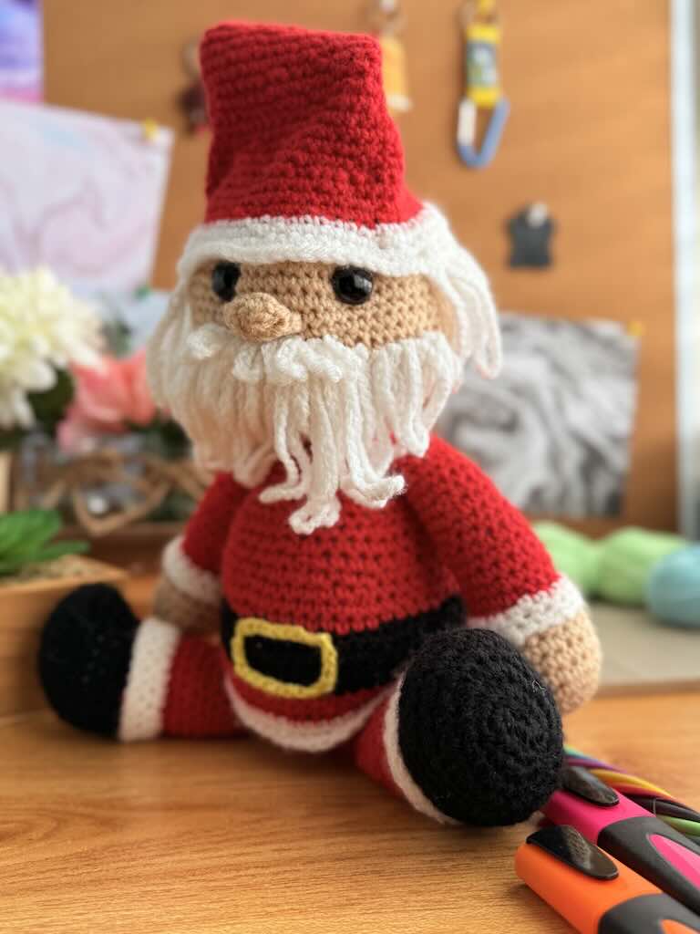 handmade crochet Santa Claus with red suit, hat, and white beard