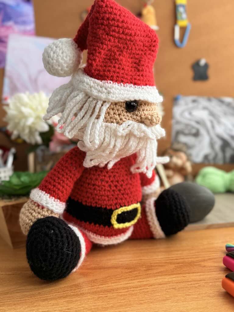 handmade crochet Santa Claus with red suit, hat, and white beard