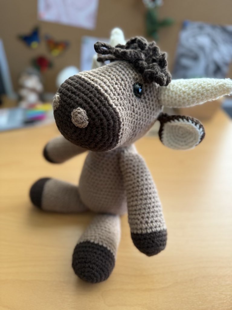 handmade crochet Highland cow with soft brown yarn and gentle horns