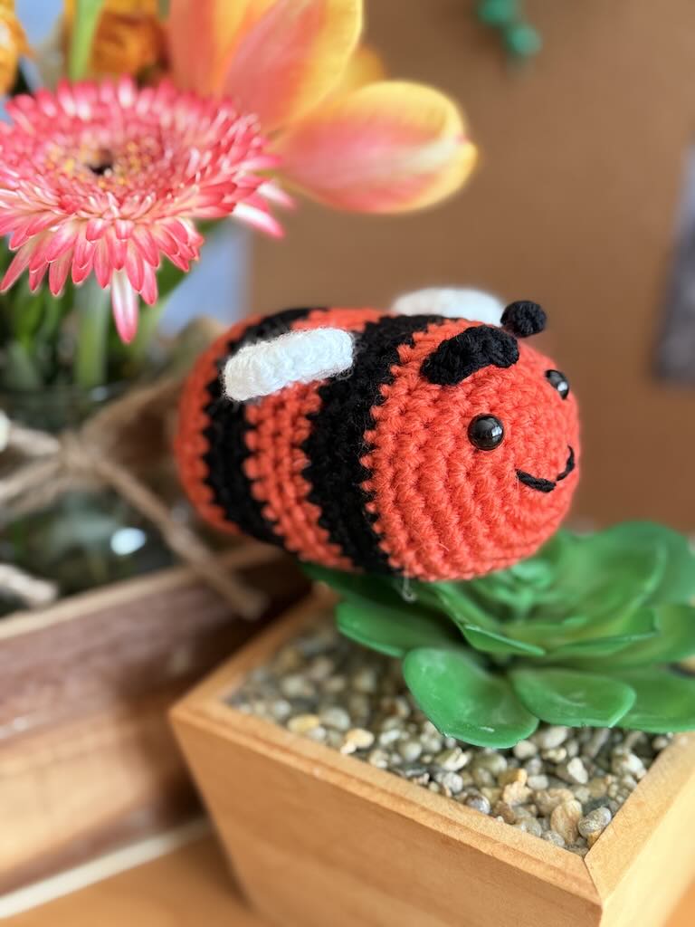 handmade crochet little bee with bright orange and black stripes