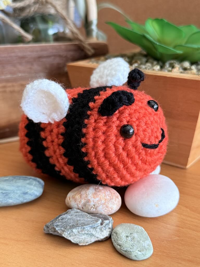 handmade crochet little bee with bright orange and black stripes