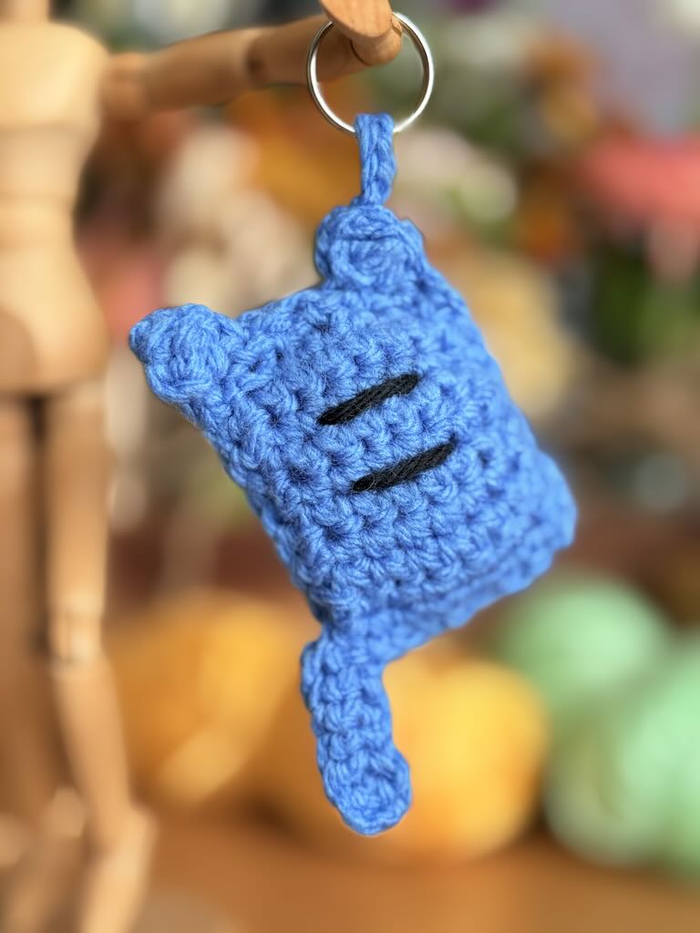 handmade keychain crochet blue cat with playful expression