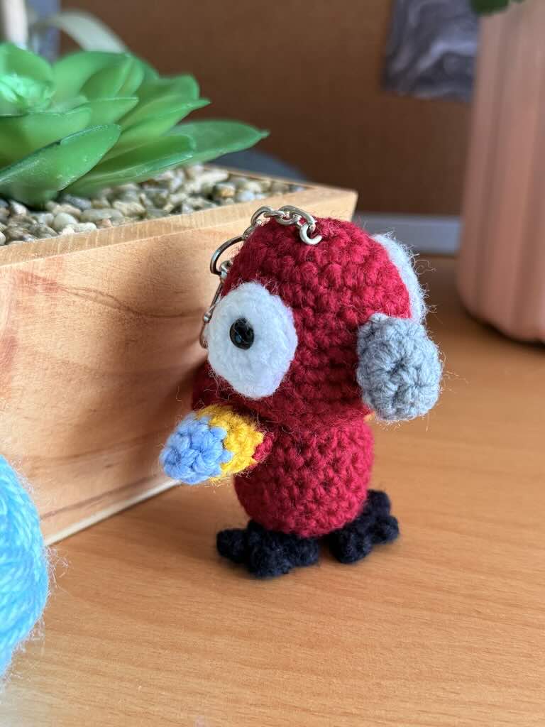 keychain crochet parrot toy with bright, colorful feathers