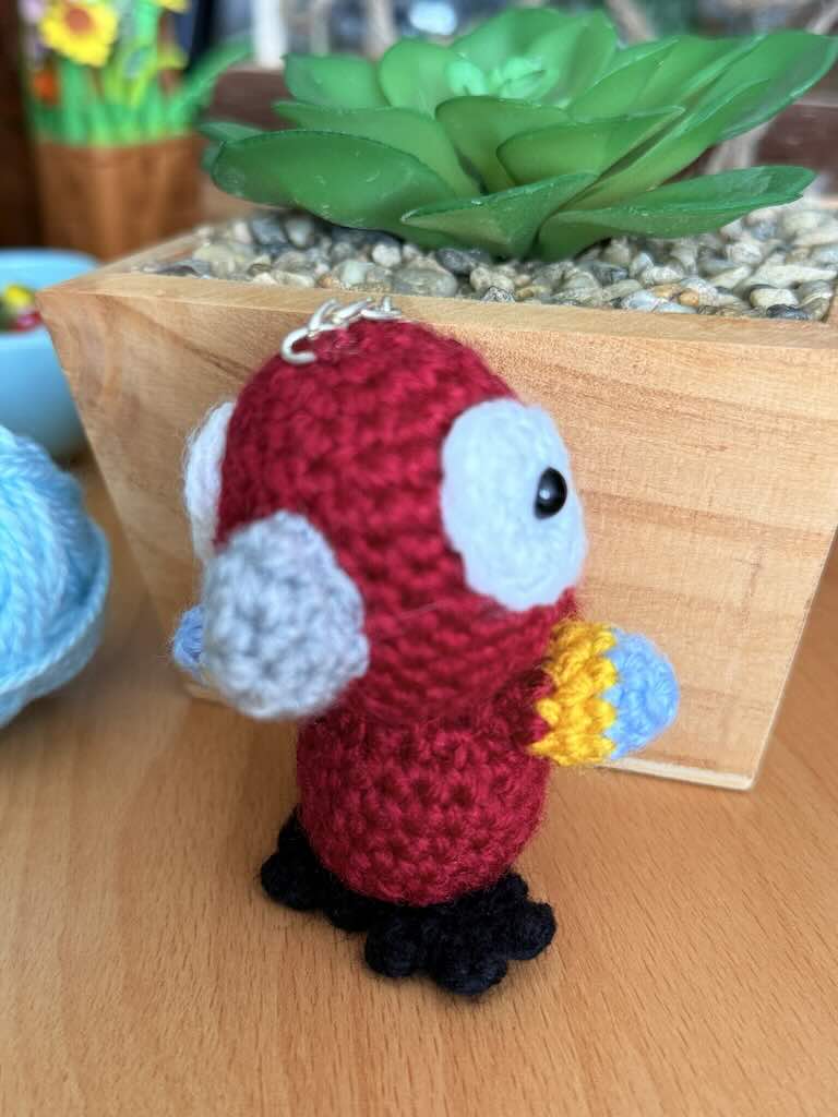 keychain crochet parrot toy with bright, colorful feathers