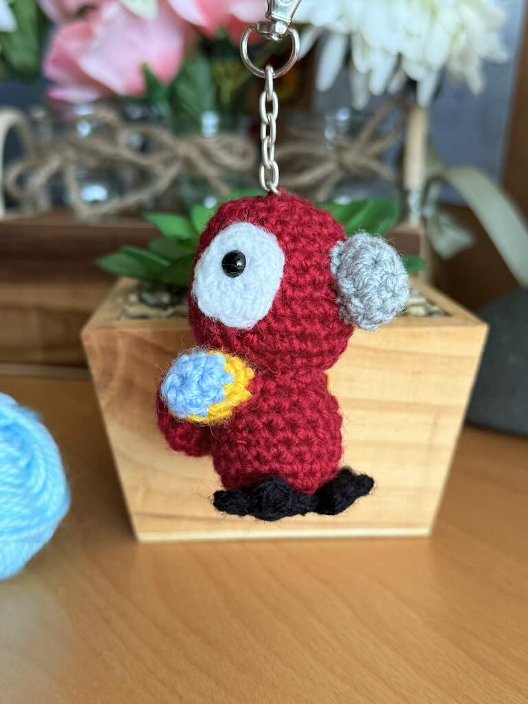 keychain crochet parrot toy with bright, colorful feathers