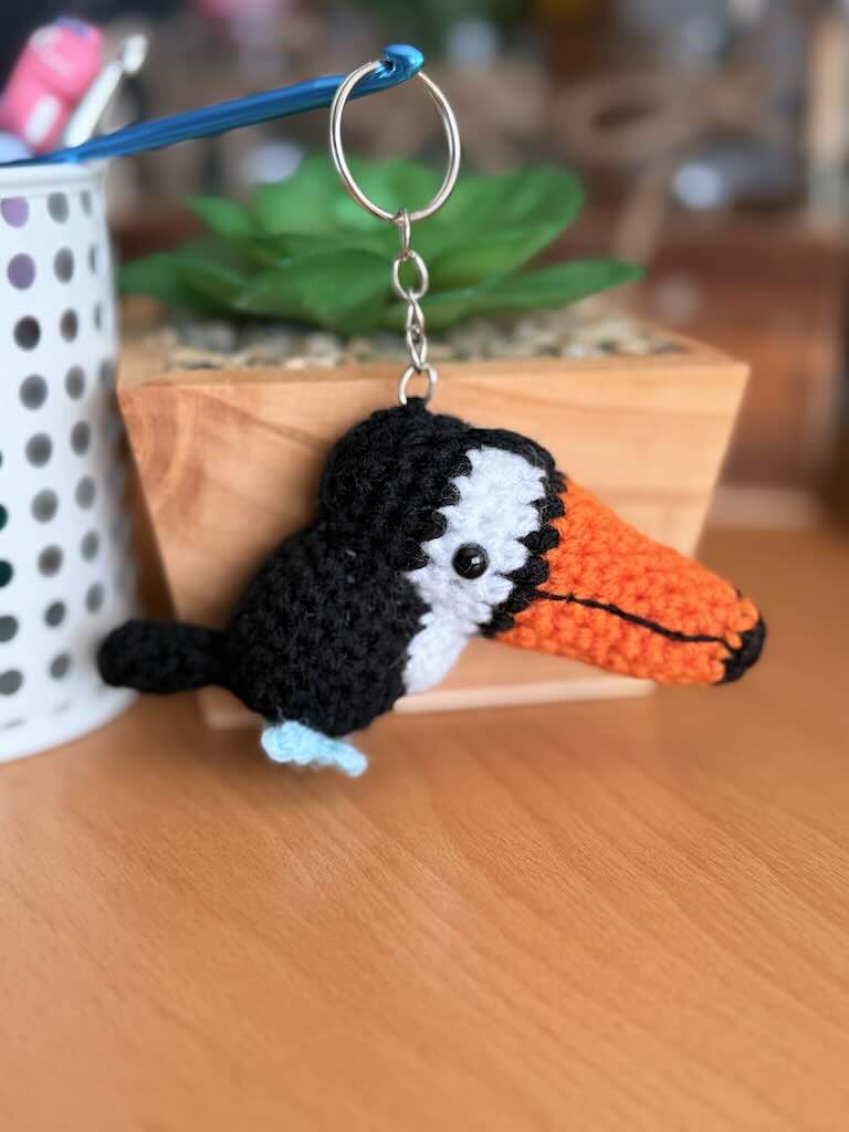 keychain crochet toucan toy with bright orange beak and black feathers