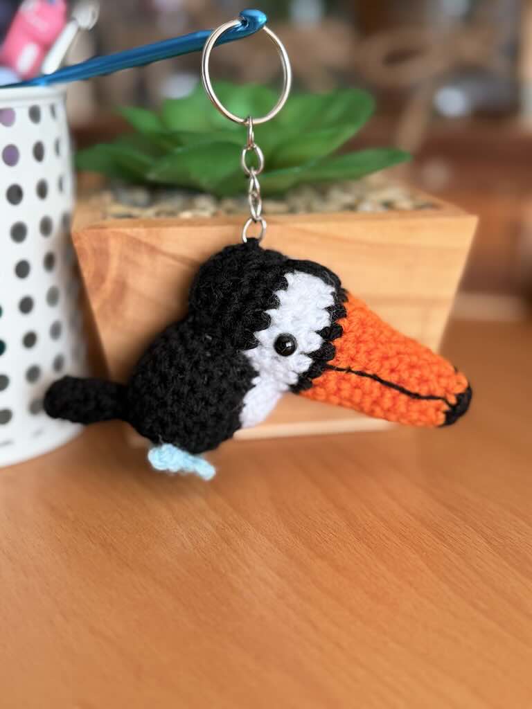 keychain crochet toucan toy with bright orange beak and black feathers