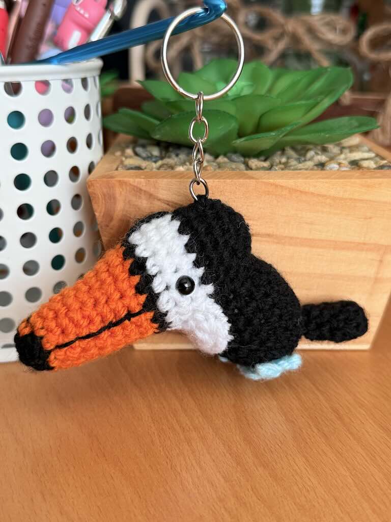 keychain crochet toucan toy with bright orange beak and black feathers
