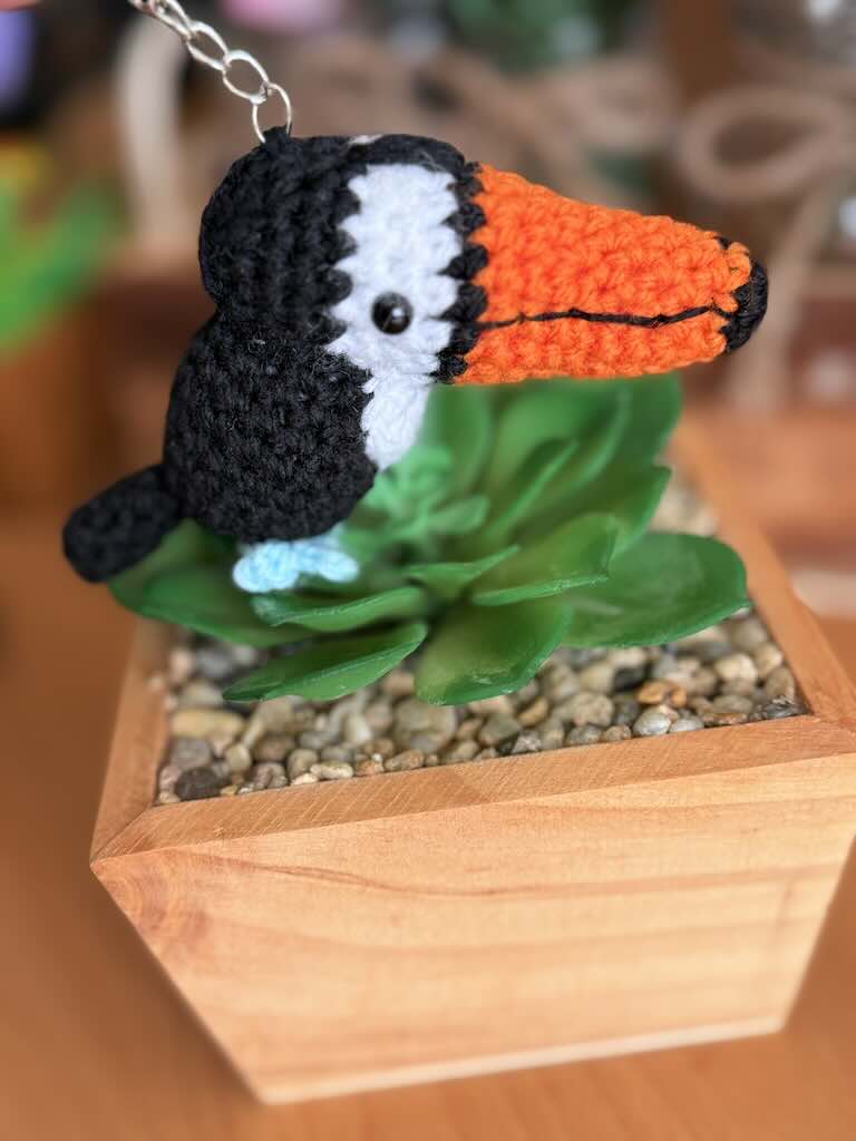 keychain crochet toucan toy with bright orange beak and black feathers