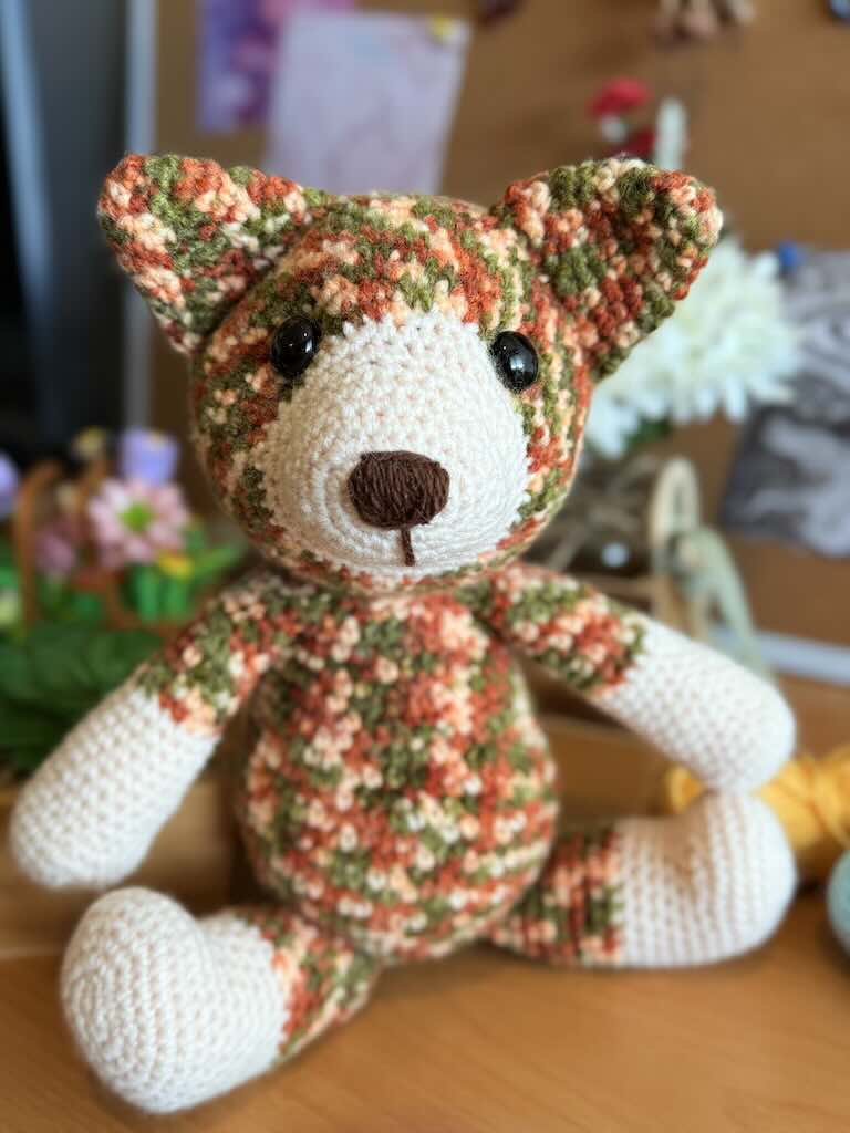 handmade colorful crochet cat named Cory with playful expression