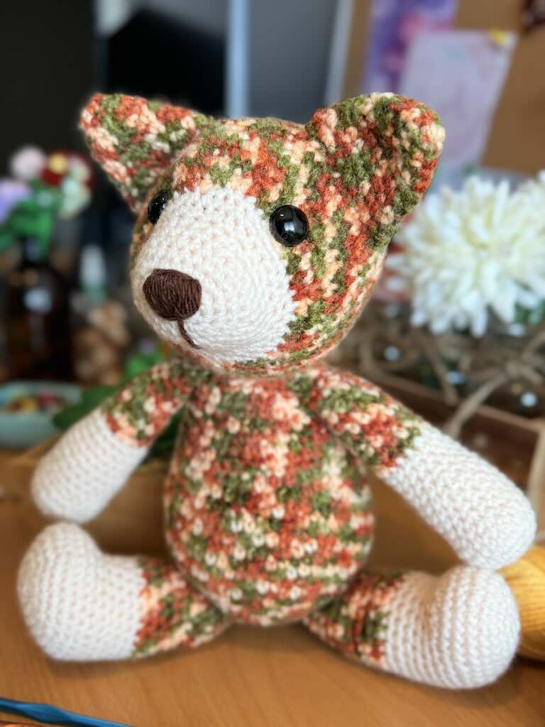 handmade colorful crochet cat named Cory with playful expression