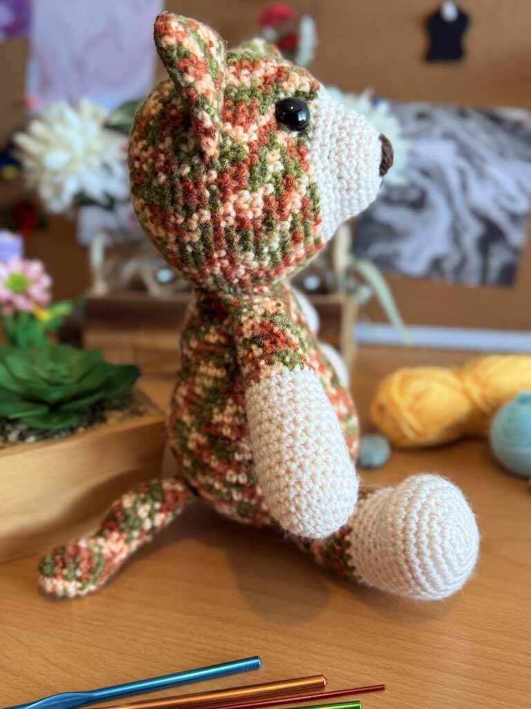 handmade colorful crochet cat named Cory with playful expression