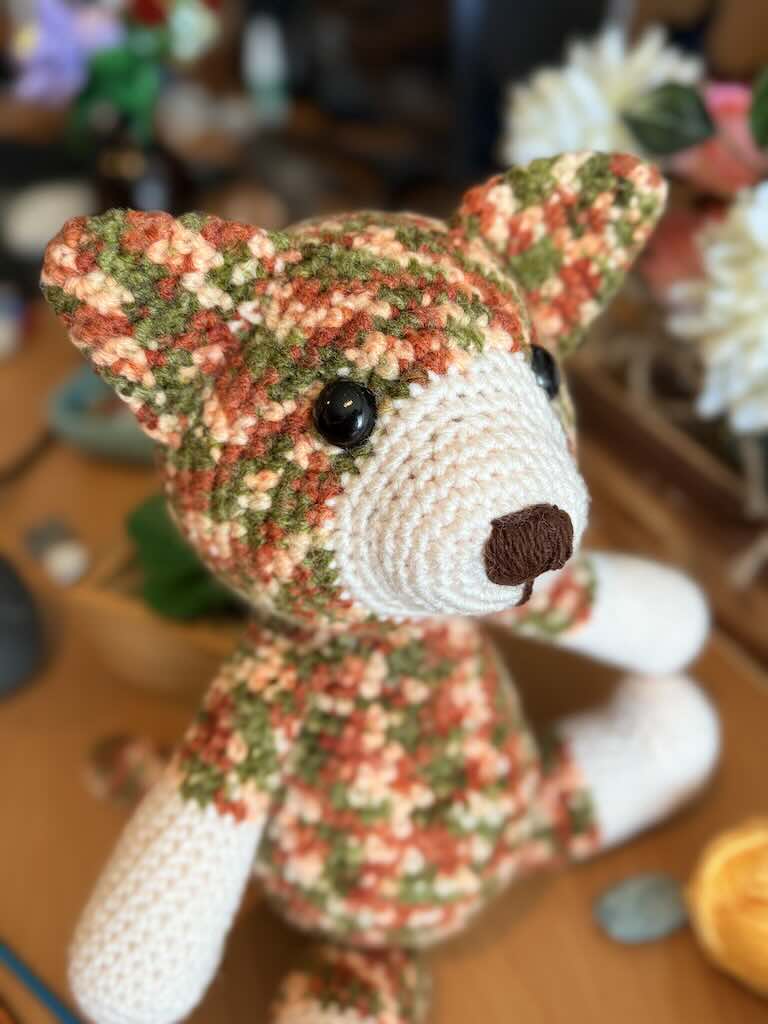 handmade colorful crochet cat named Cory with playful expression