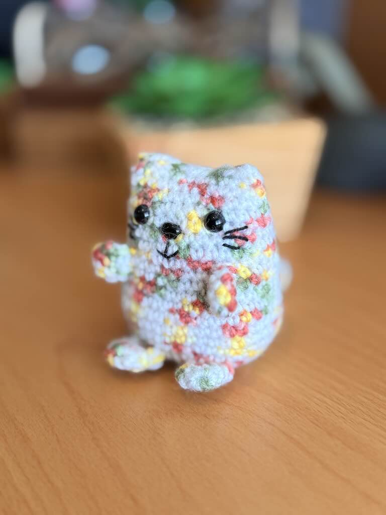 handmade crochet cat named Pookie with soft white body and colorful fur
