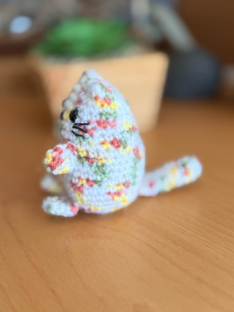 handmade crochet cat named Pookie with soft white body and colorful fur