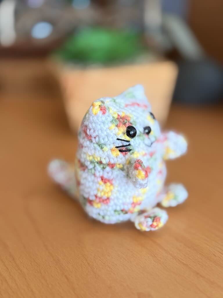 handmade crochet cat named Pookie with soft white body and colorful fur