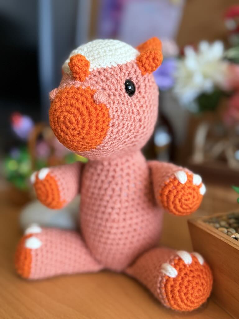 handmade crochet pink Stygimoloch dinosaur toy named Shaun with spiky head