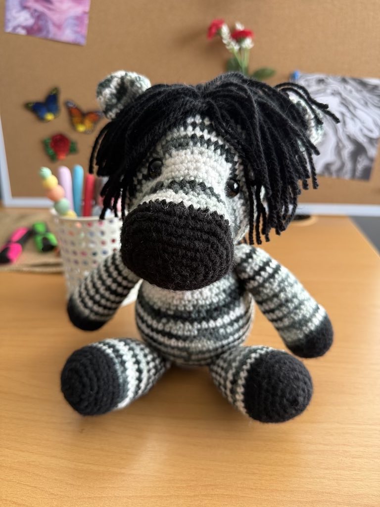 handmade crochet zebra toy named Zane with black and white stripes