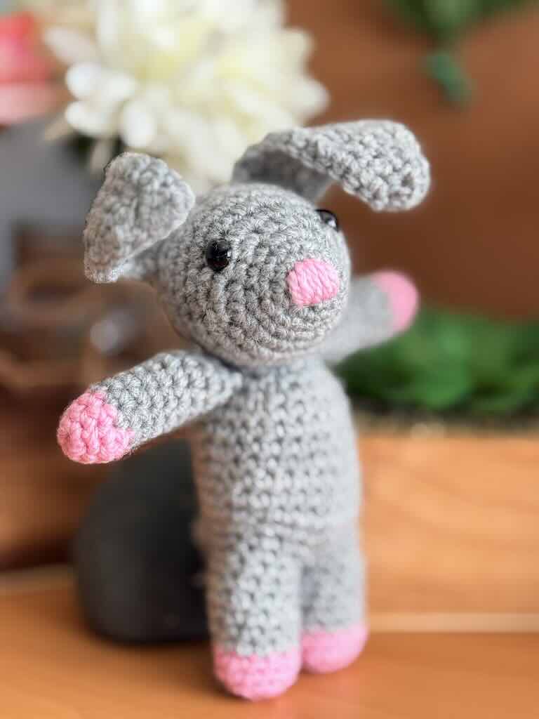 handmade crochet bunny toy named Benny with cute floppy ears and pink paws