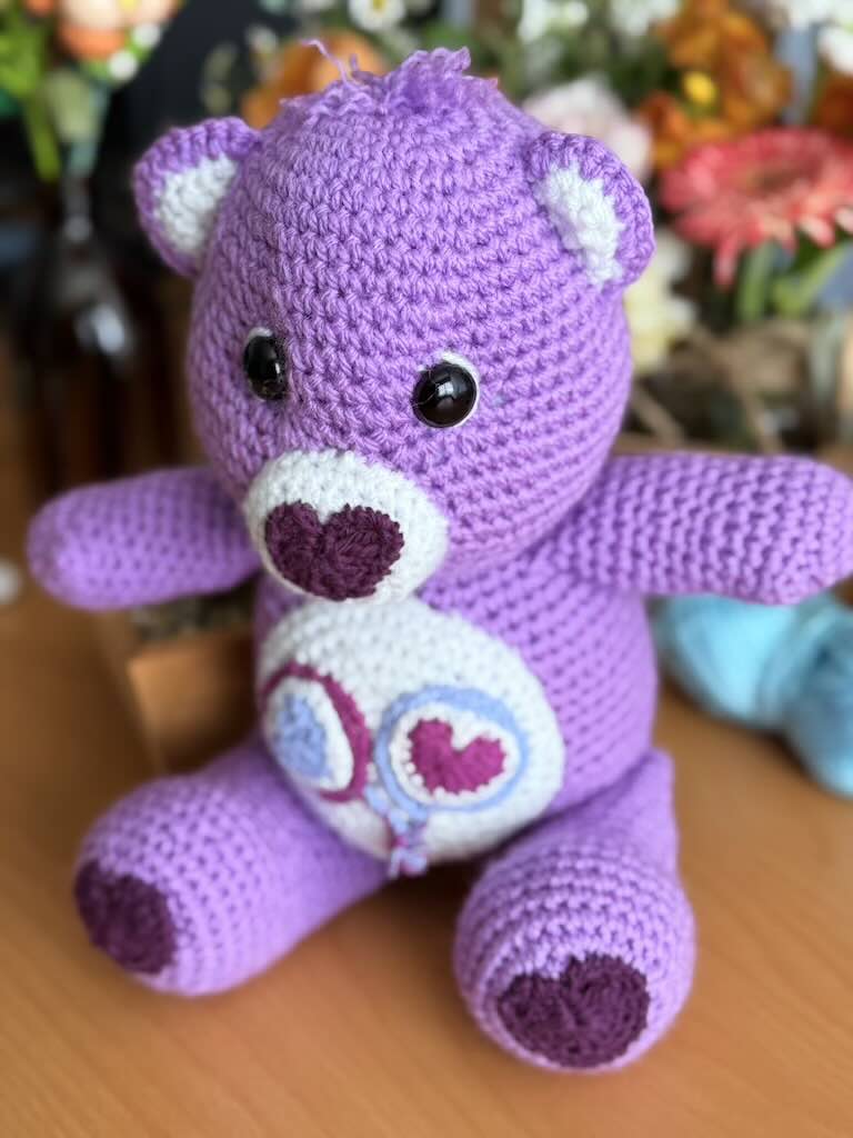 handmade crochet purple bear toy named Carrie inspired by Care Bears with cheerful look