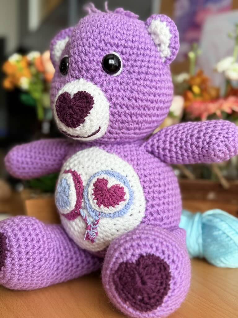 handmade crochet purple bear toy named Carrie inspired by Care Bears with cheerful look