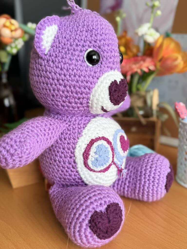 handmade crochet purple bear toy named Carrie inspired by Care Bears with cheerful look