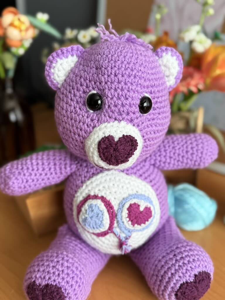 handmade crochet purple bear toy named Carrie inspired by Care Bears with cheerful look