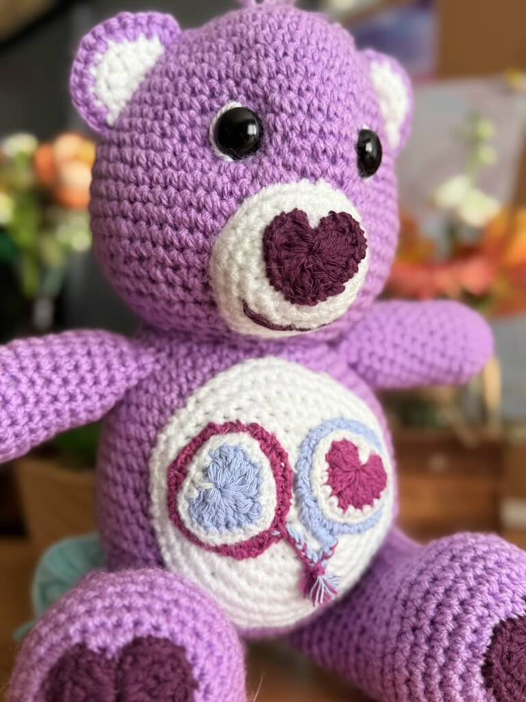 handmade crochet purple bear toy named Carrie inspired by Care Bears with cheerful look
