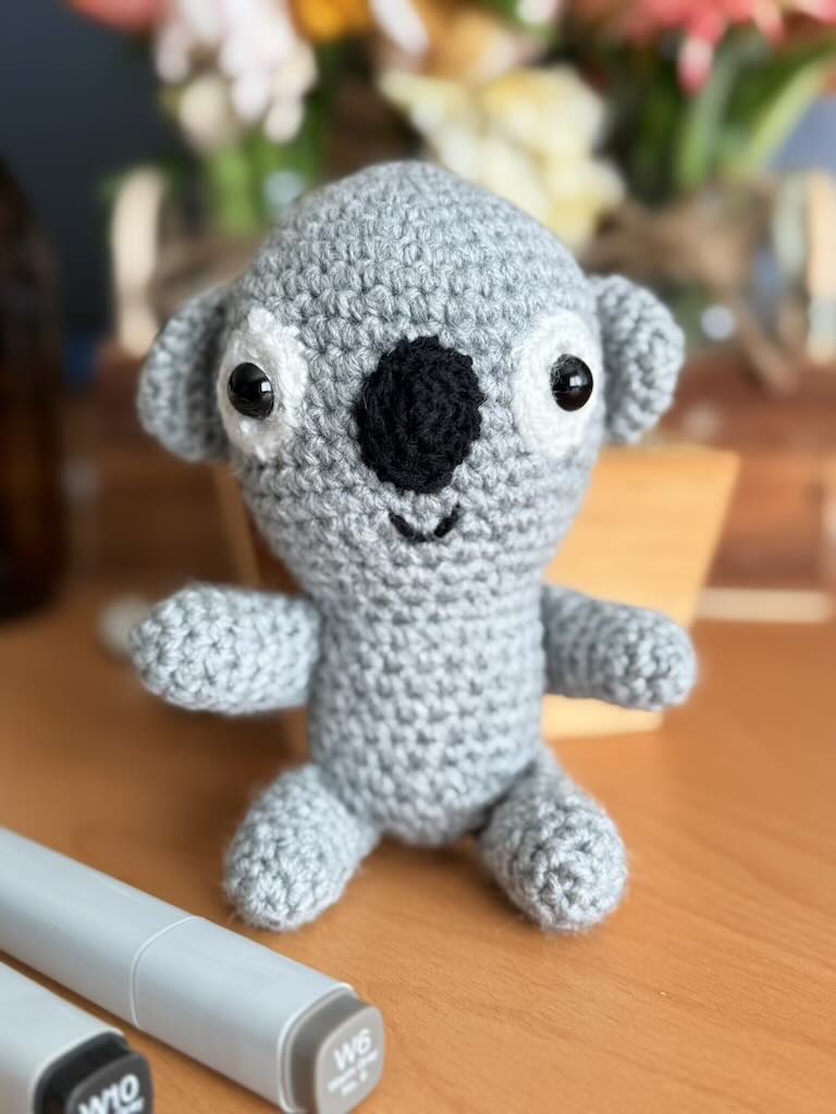 handmade crochet koala toy named Kelvin with grey fur and black nose