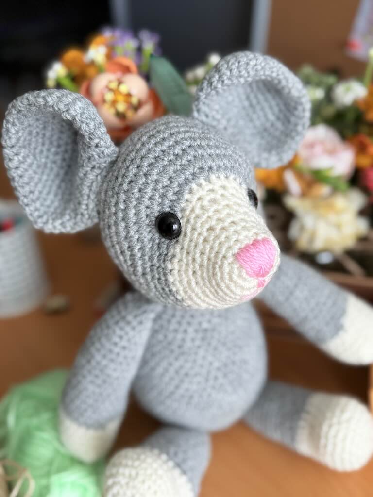 handmade crochet mouse toy named Mindy with tiny ears and pink nose