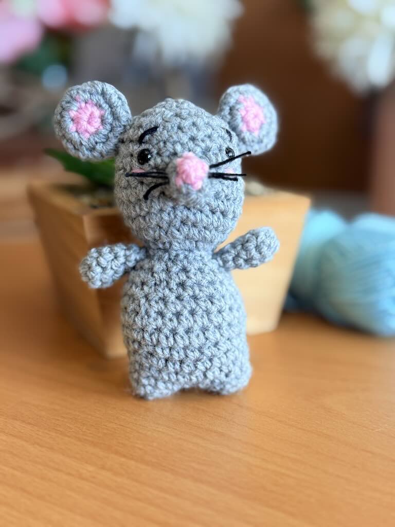 handmade crochet mouse toy named Minki with pink ears and nose
