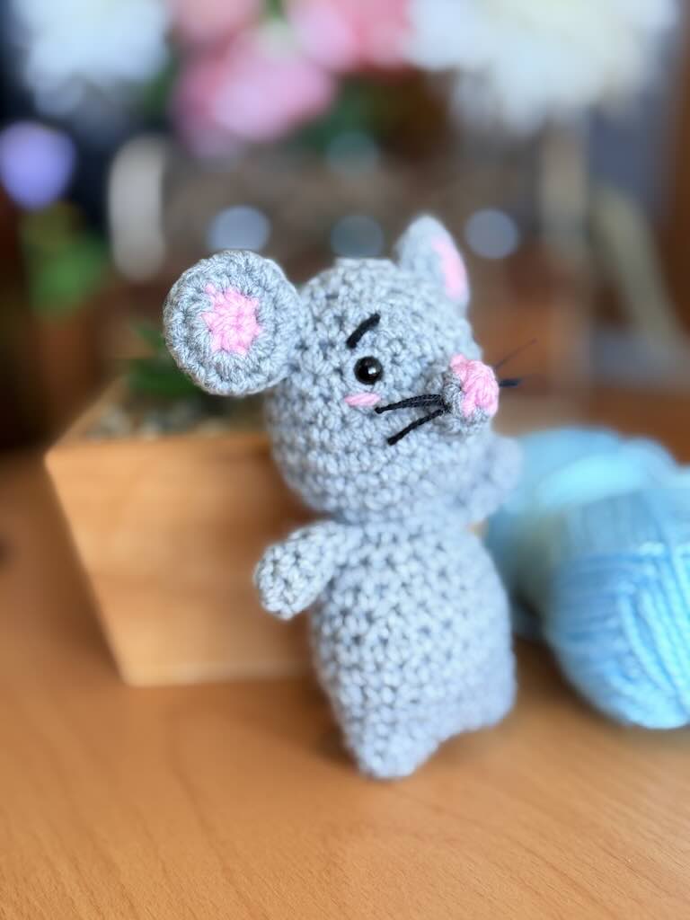 handmade crochet mouse toy named Minki with pink ears and nose