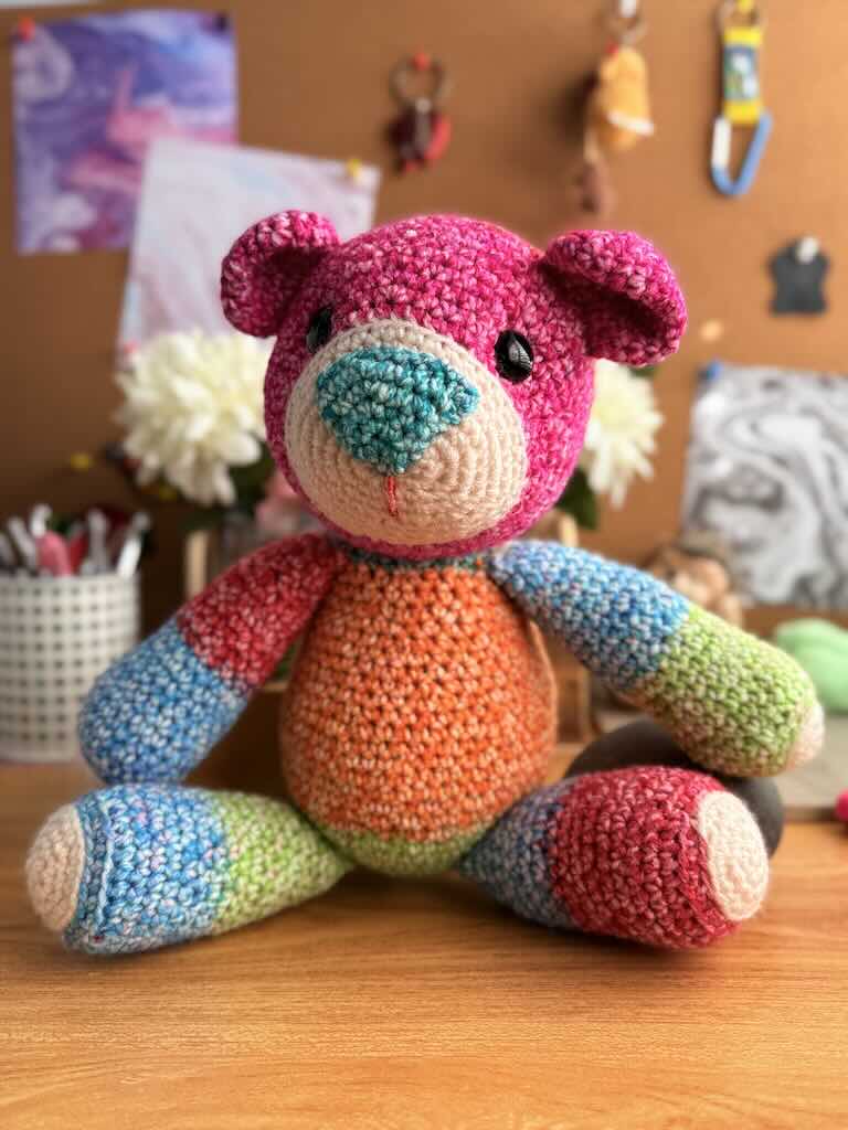 handmade crochet teddy bear named Ribbon with soft yarn and full of color