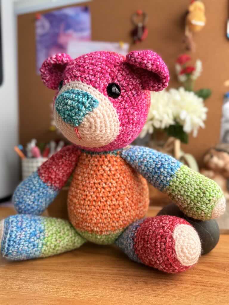 handmade crochet teddy bear named Ribbon with soft yarn and full of color