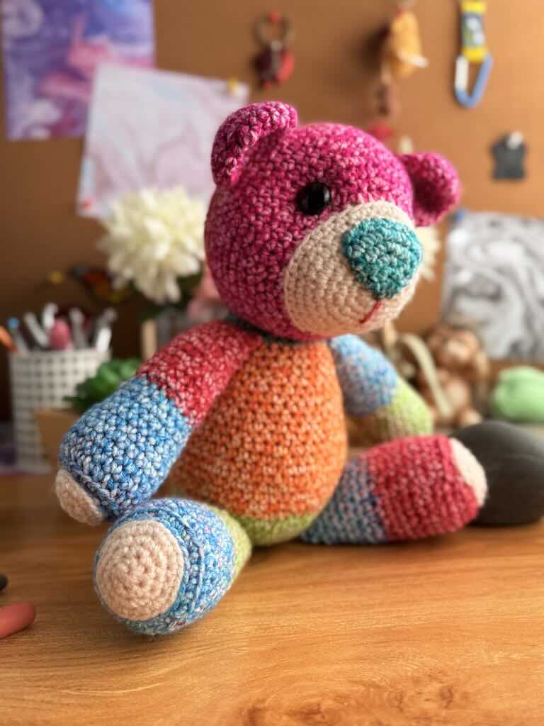 handmade crochet teddy bear named Ribbon with soft yarn and full of color