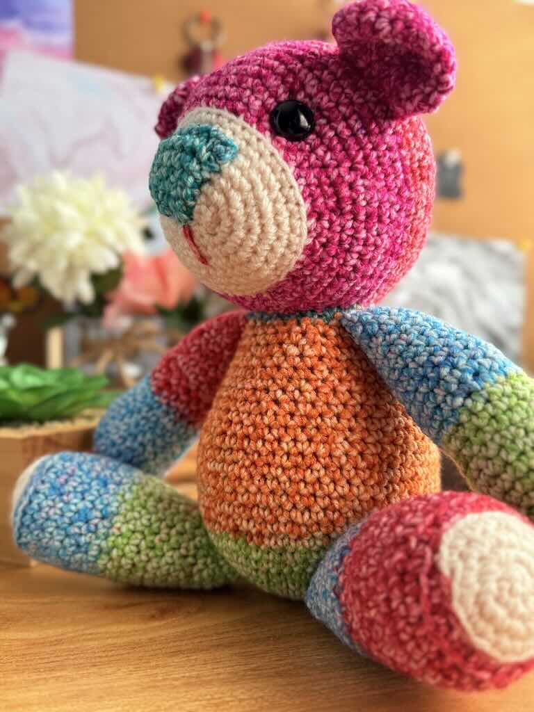 handmade crochet teddy bear named Ribbon with soft yarn and full of color