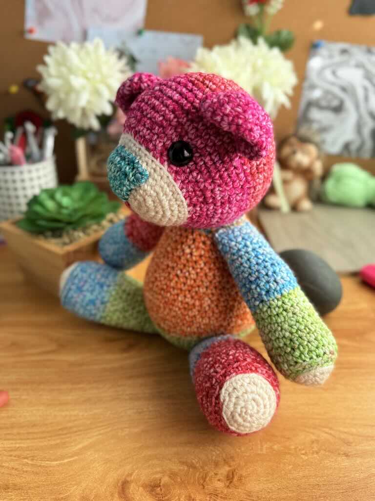 handmade crochet teddy bear named Ribbon with soft yarn and full of color