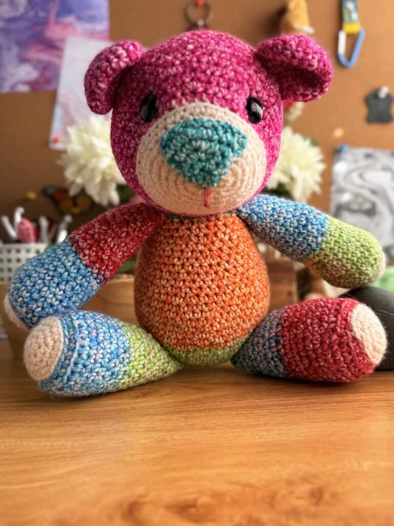 handmade crochet teddy bear named Ribbon with soft yarn and full of color