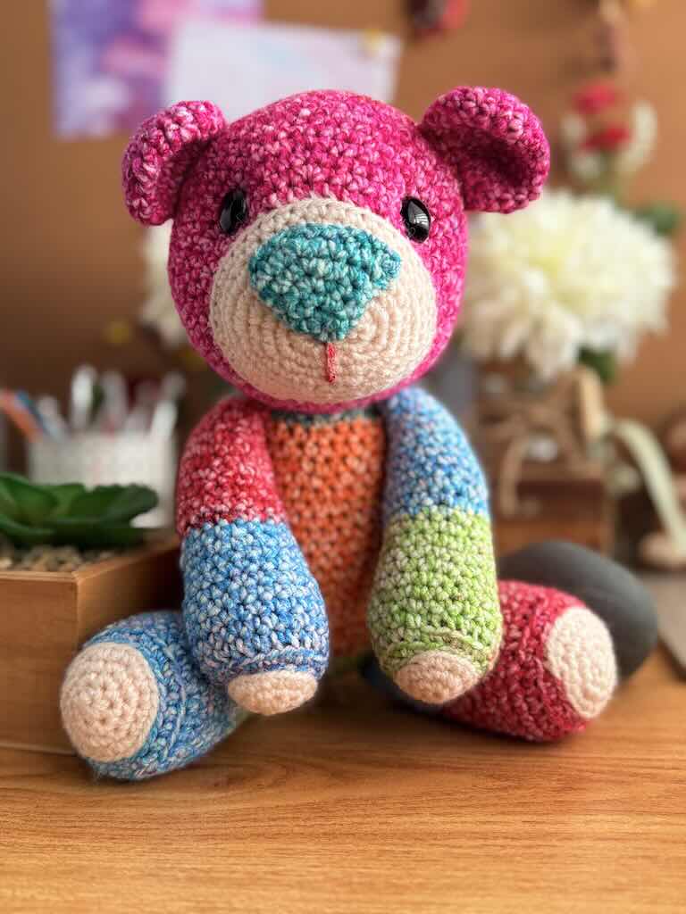 handmade crochet teddy bear named Ribbon with soft yarn and full of color